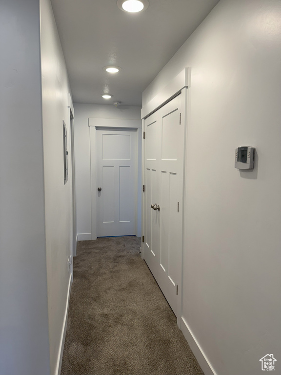 Hallway with carpet, baseboards, and recessed lighting