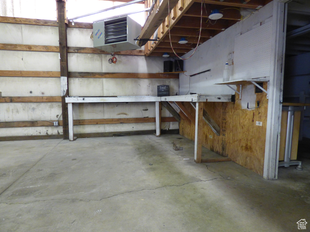 Unfinished basement featuring a heating unit