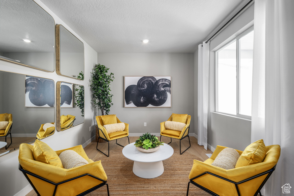 Sitting room with recessed lighting, baseboards, and wood finished floors
