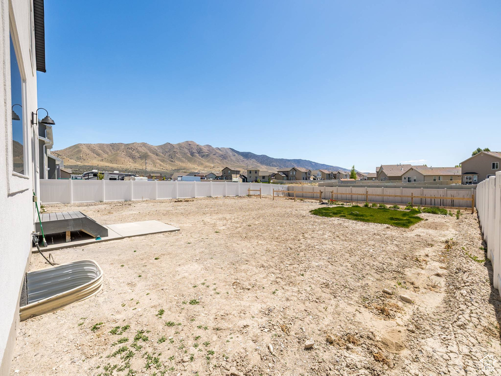 View of yard featuring a mountain view and a fenced backyard