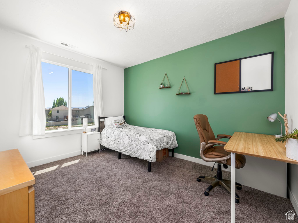 Bedroom with baseboards, visible vents, and carpet