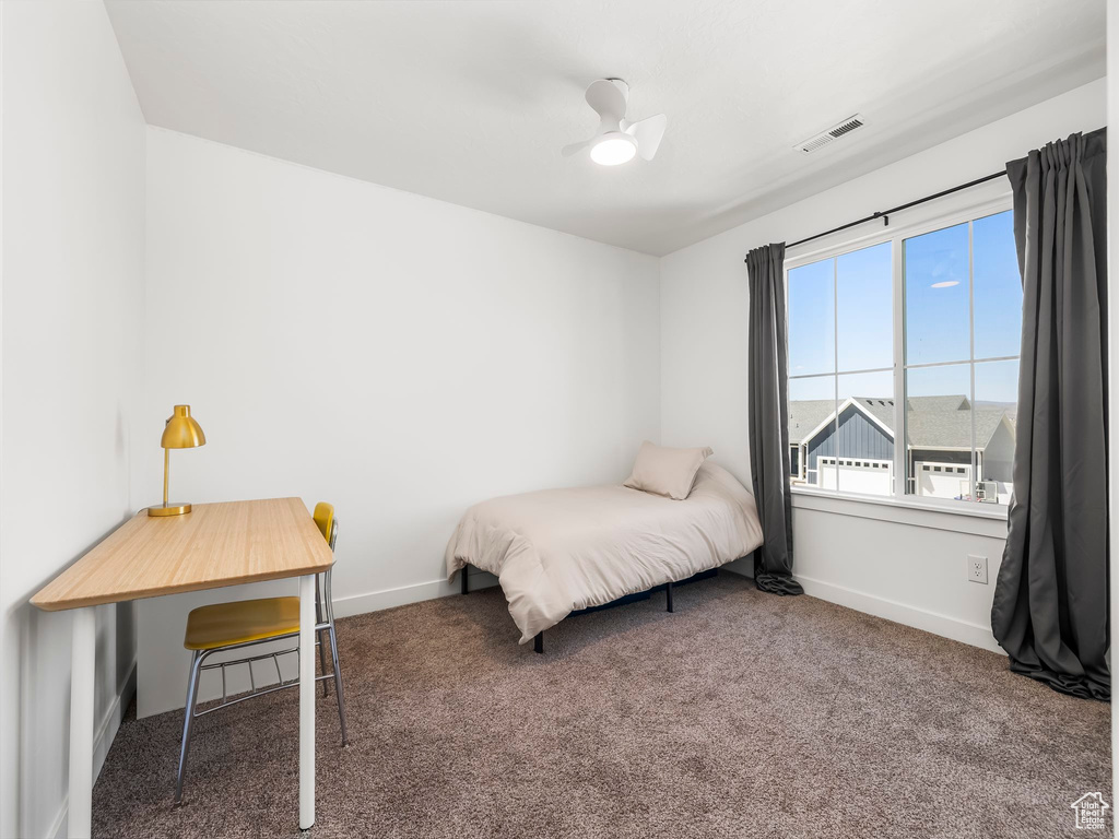 Bedroom featuring baseboards, ceiling fan, carpet flooring, and visible vents