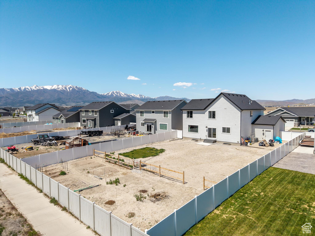 Exterior space with a mountain view, a residential view, and a fenced backyard