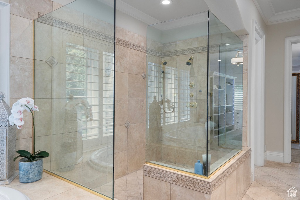 Bathroom with tile patterned flooring, ornamental molding, tiled shower, and recessed lighting