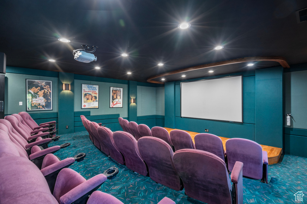 Carpeted cinema room with visible vents, a decorative wall, and recessed lighting