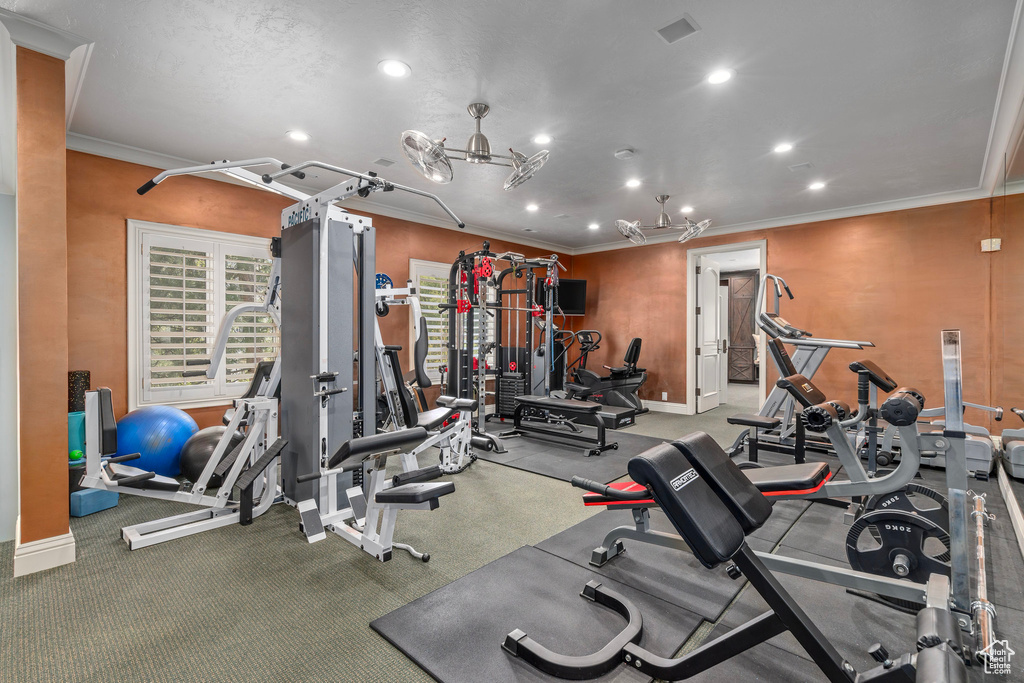 Workout area with crown molding, baseboards, and recessed lighting