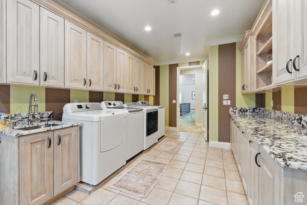 Laundry area with washing machine and dryer, recessed lighting, a sink, crown molding, and cabinet space