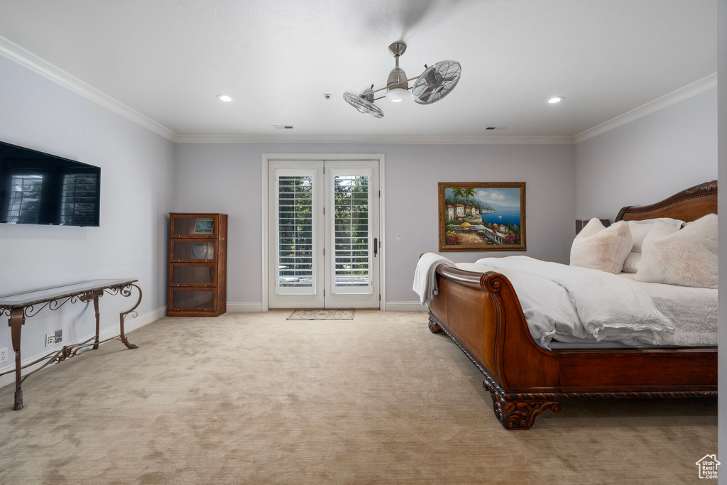 Carpeted bedroom featuring crown molding, recessed lighting, baseboards, and access to exterior