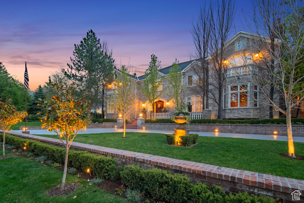 Exterior space with a yard and stone siding