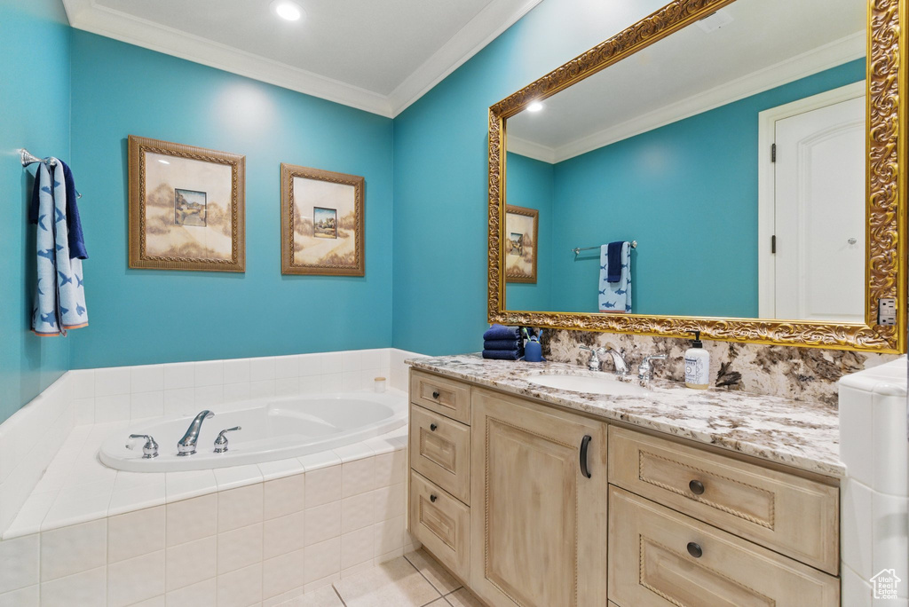 Bathroom with recessed lighting, a bath, tile patterned flooring, vanity, and crown molding