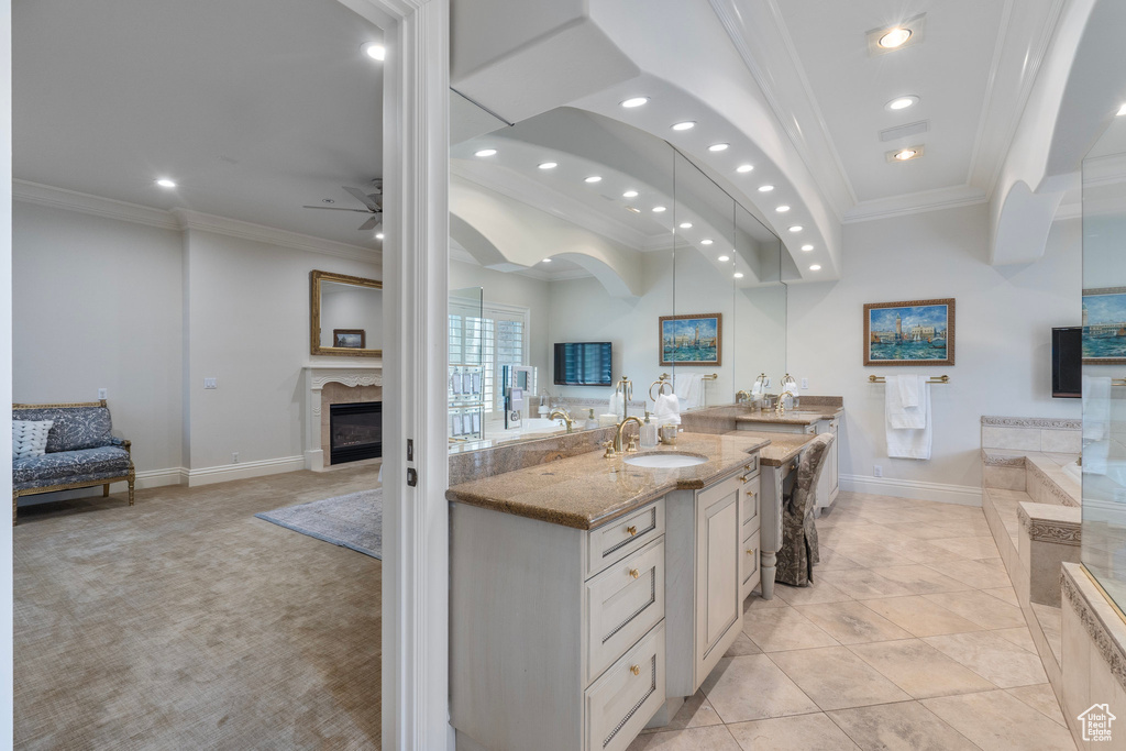 Kitchen with crown molding, a sink, open floor plan, and recessed lighting