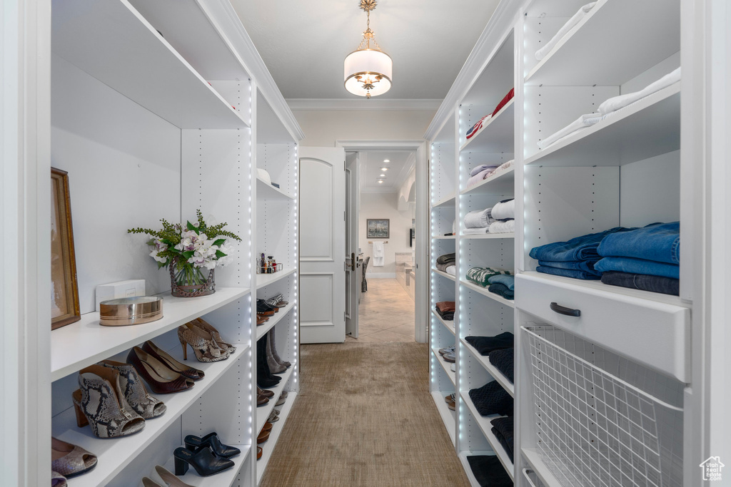 Walk in closet with light tile patterned floors