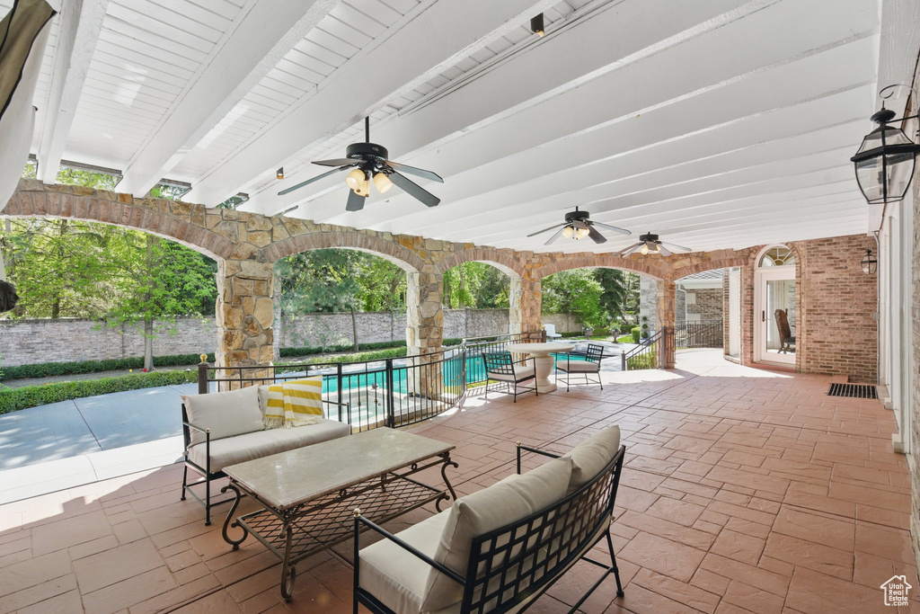 View of patio / terrace featuring ceiling fan, outdoor lounge area, and a fenced in pool