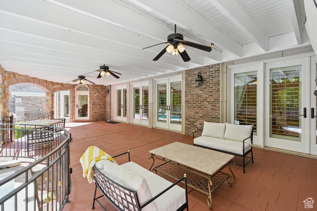View of patio with an outdoor hangout area, french doors, and a ceiling fan