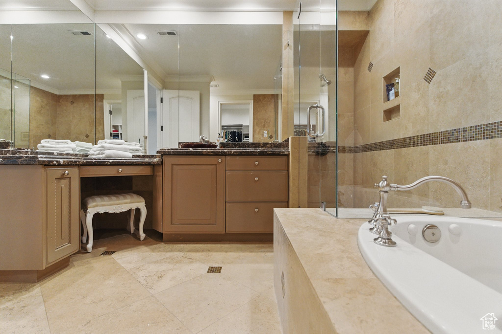 Full bath with vanity, visible vents, a stall shower, crown molding, and a garden tub