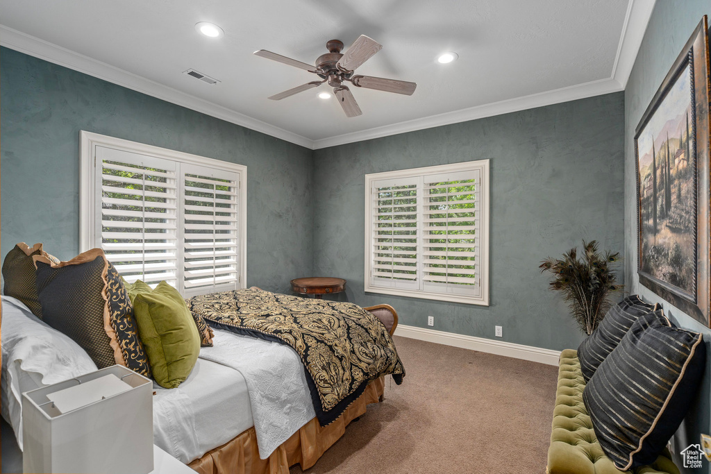 Carpeted bedroom with visible vents, recessed lighting, crown molding, a ceiling fan, and baseboards