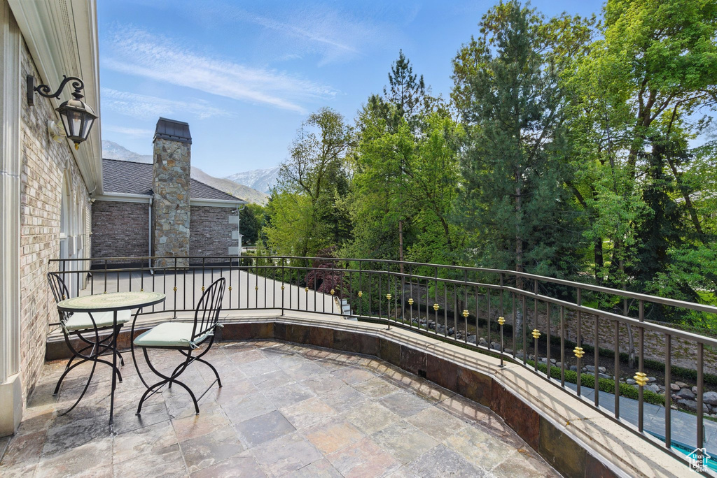 View of patio featuring a mountain view and a balcony