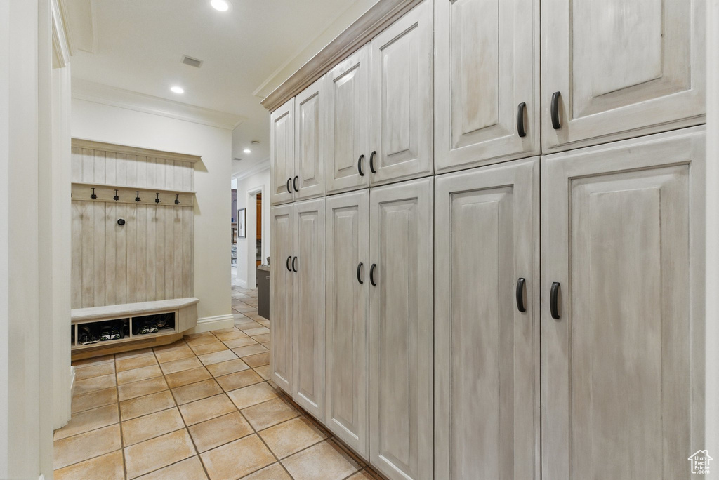 Mudroom with light tile patterned floors, crown molding, visible vents, baseboards, and recessed lighting