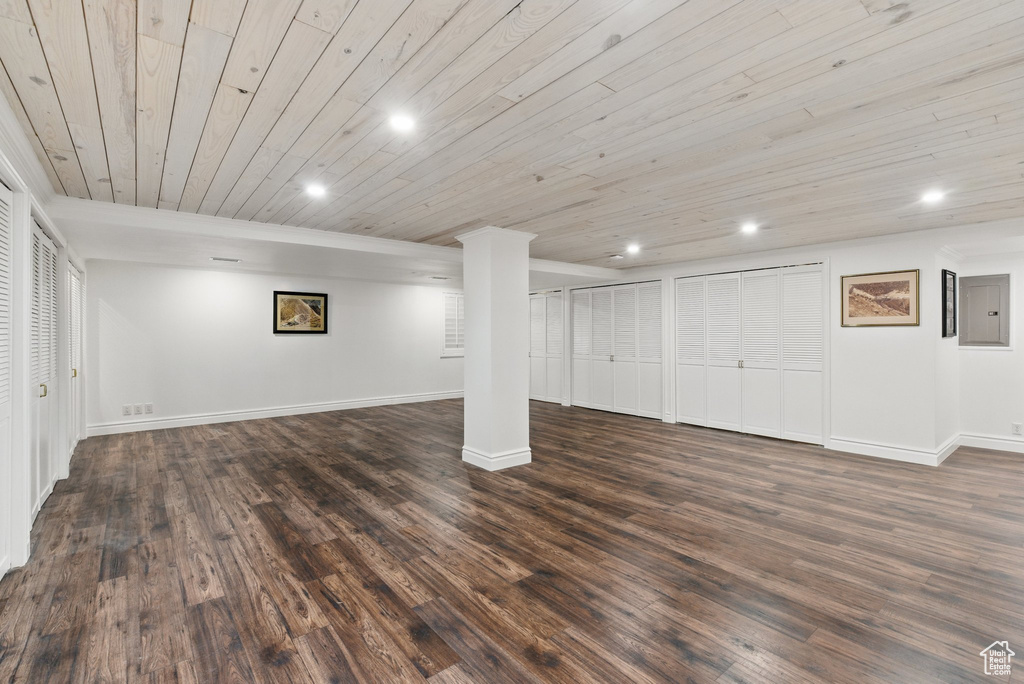 Finished below grade area featuring baseboards, recessed lighting, wooden ceiling, and dark wood-type flooring