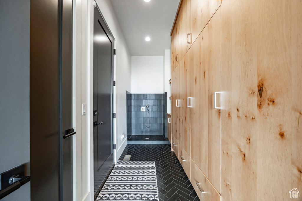Corridor featuring baseboards and recessed lighting