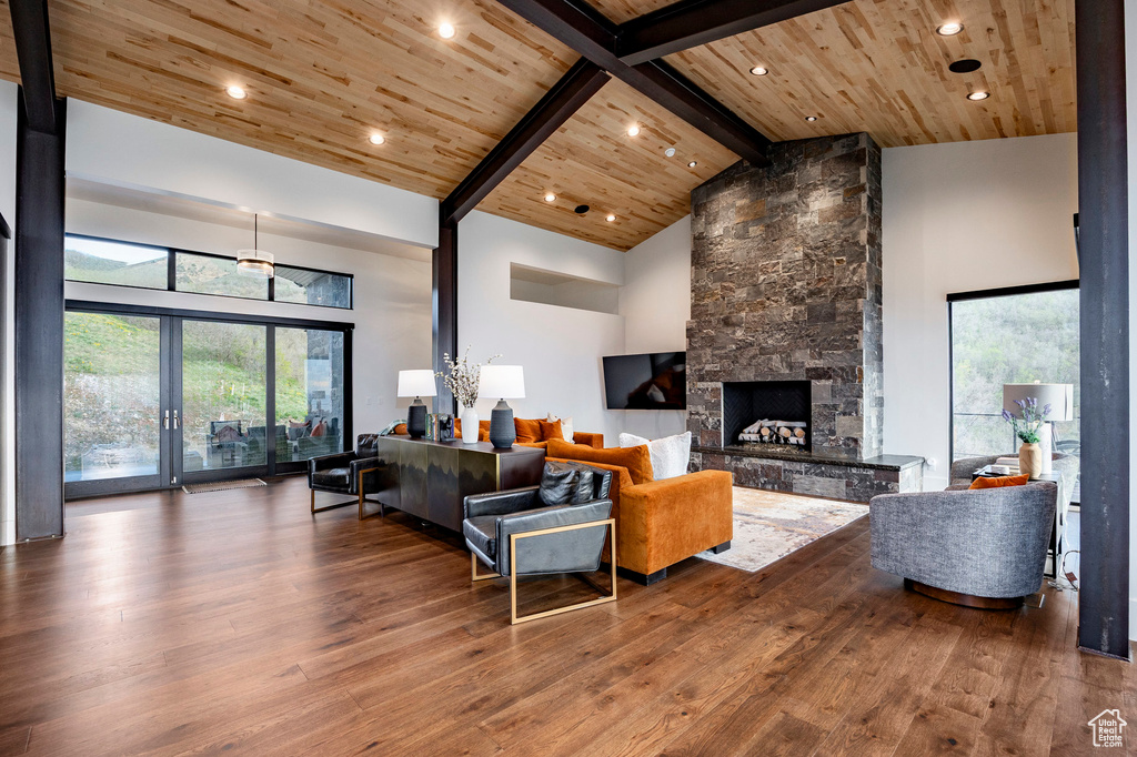 Living room featuring a fireplace, wood ceiling, and wood-type flooring