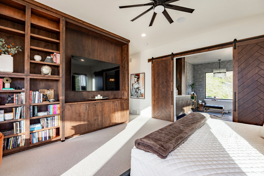 Carpeted bedroom with a barn door