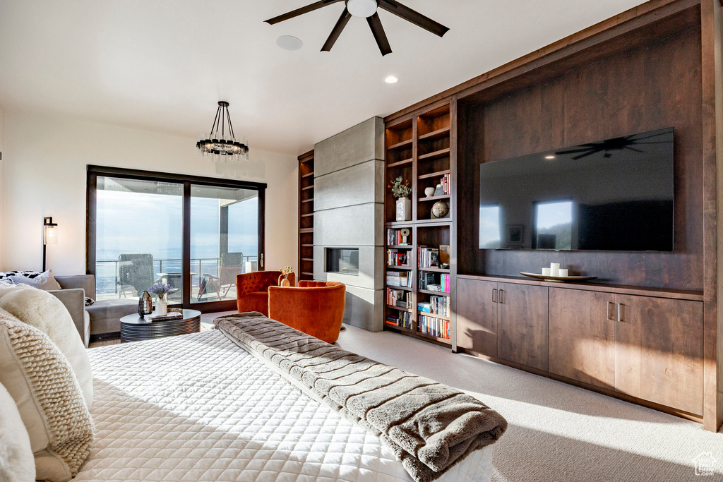 Bedroom featuring carpet flooring, a tiled fireplace, recessed lighting, and access to exterior