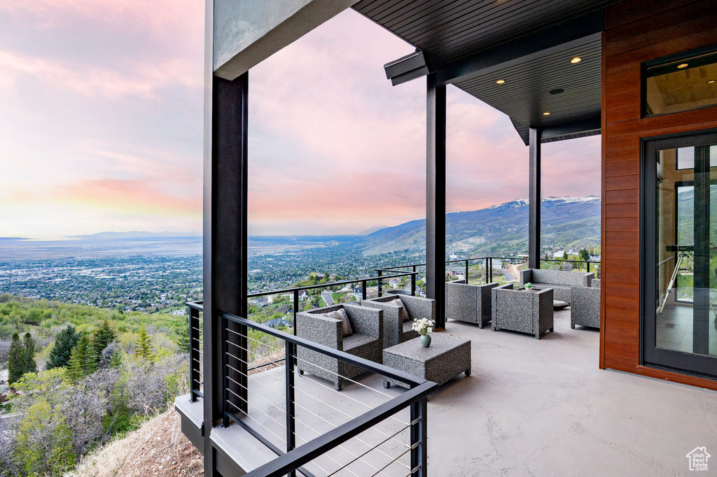 Balcony at dusk with a mountain view and outdoor lounge area