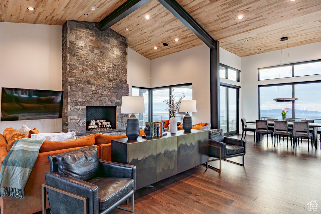 Living area with wooden ceiling, wood finished floors, beam ceiling, and high vaulted ceiling