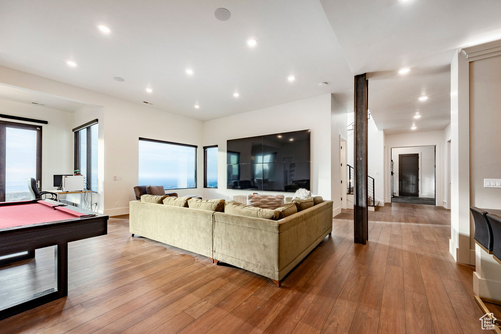 Living room with baseboards, hardwood / wood-style floors, pool table, and recessed lighting