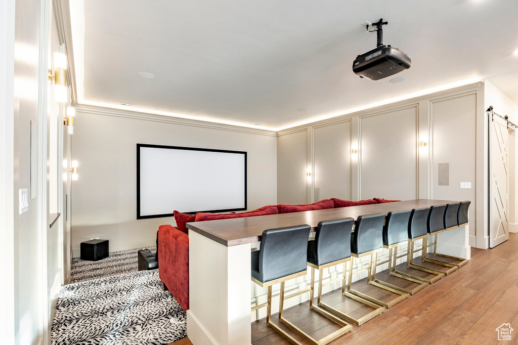 Home theater with light wood-style floors