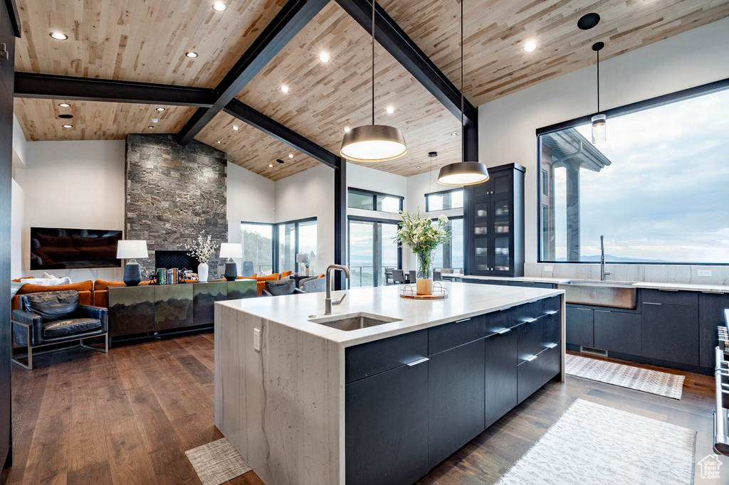 Kitchen featuring modern cabinets, wood ceiling, dark wood finished floors, and a sink