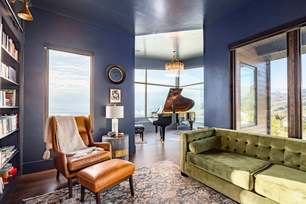 Living room featuring wood finished floors and a notable chandelier