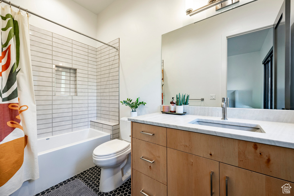 Full bath featuring vanity, toilet, shower / bath combination with curtain, and tile patterned flooring