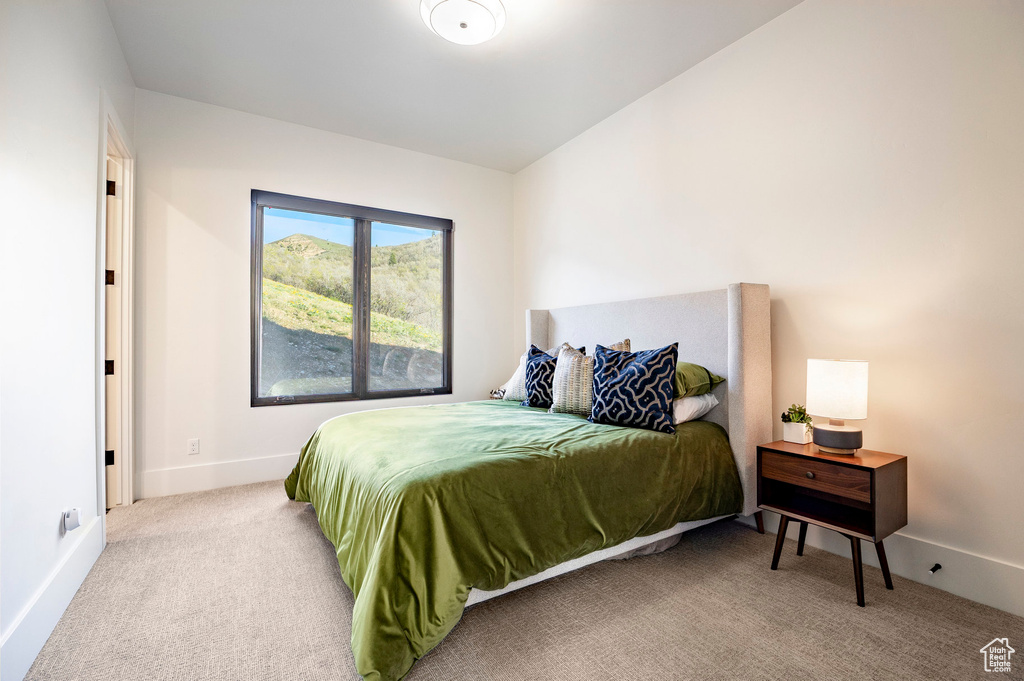 Bedroom with carpet flooring and baseboards