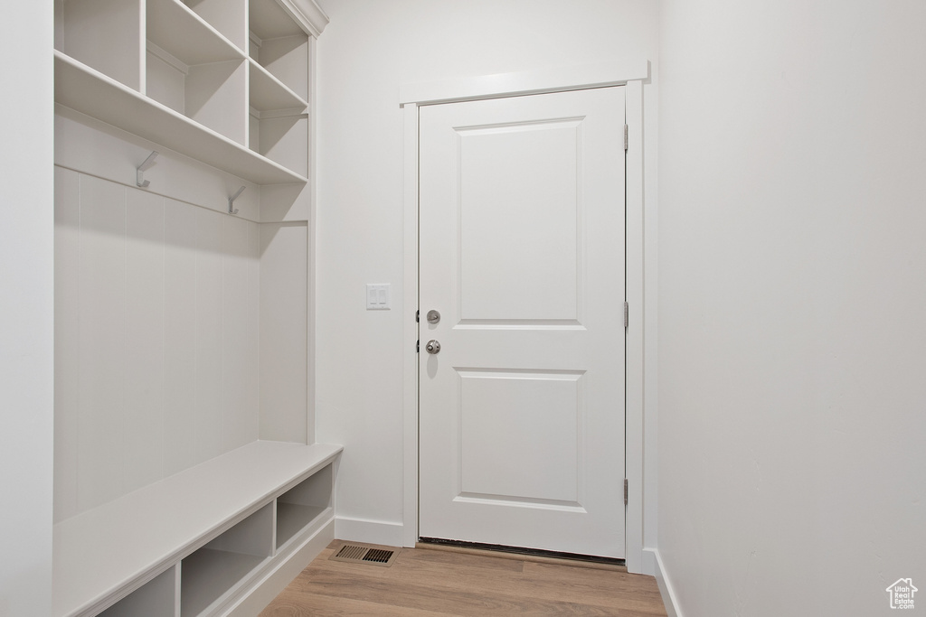 Mudroom featuring baseboards and light wood-style flooring
