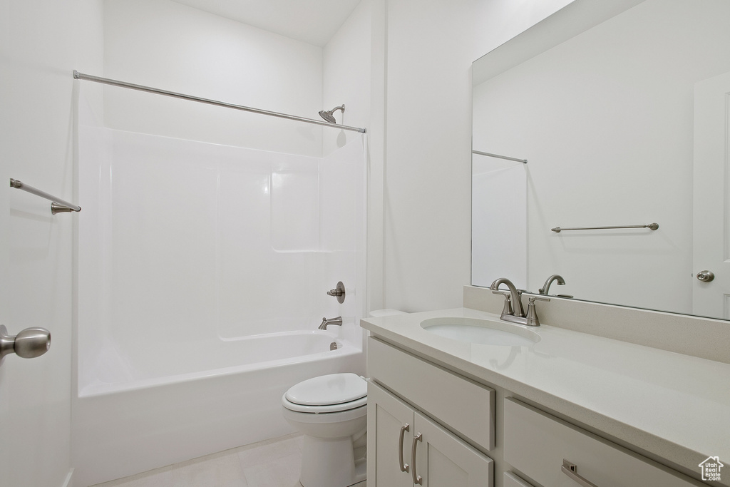 Bathroom with toilet, tub / shower combination, and vanity