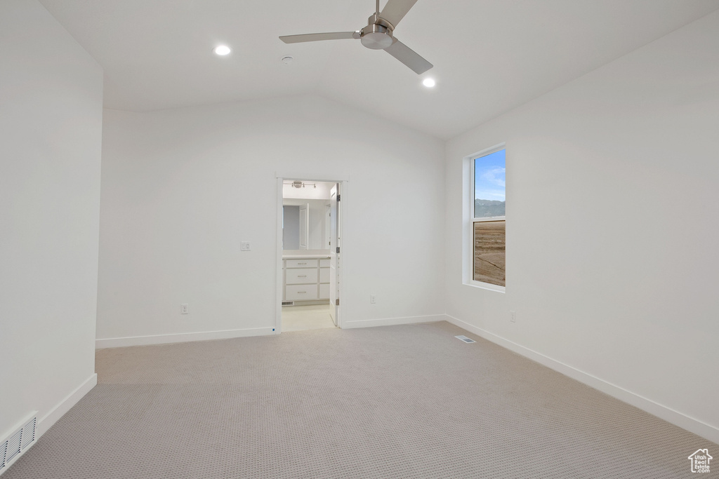 Unfurnished bedroom featuring vaulted ceiling, visible vents, and baseboards