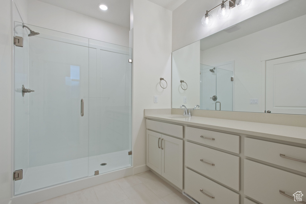 Full bath with vanity, tile patterned flooring, a shower stall, and recessed lighting