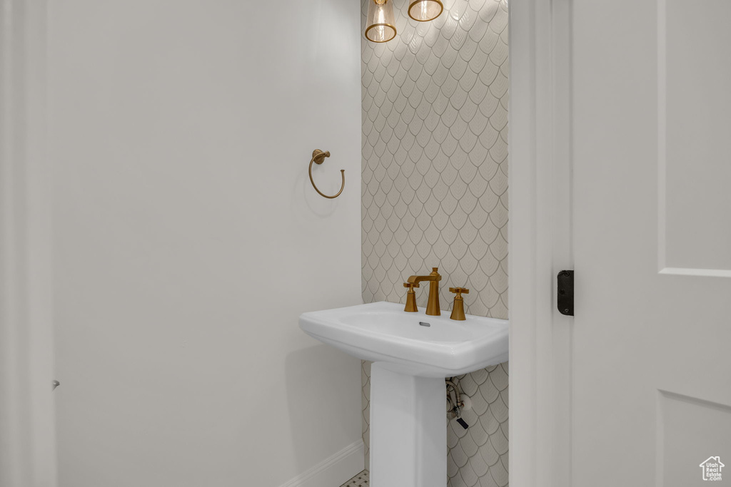 Bathroom with baseboards and a sink