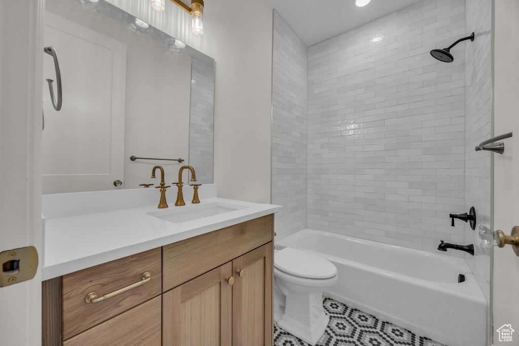 Full bath featuring tile patterned floors, toilet, bathing tub / shower combination, and vanity