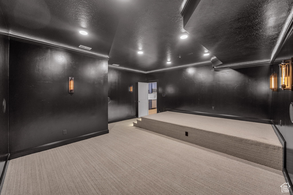 Carpeted cinema with recessed lighting, baseboards, ornamental molding, and a textured ceiling