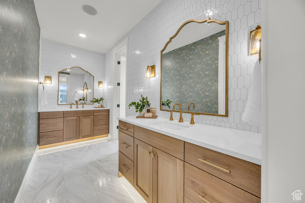 Bathroom with two vanities and marble finish floors
