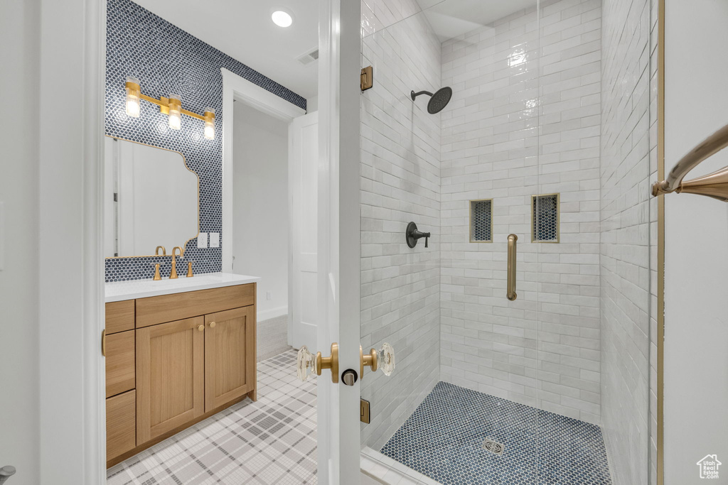 Full bathroom featuring a stall shower, tile patterned flooring, vanity, and recessed lighting