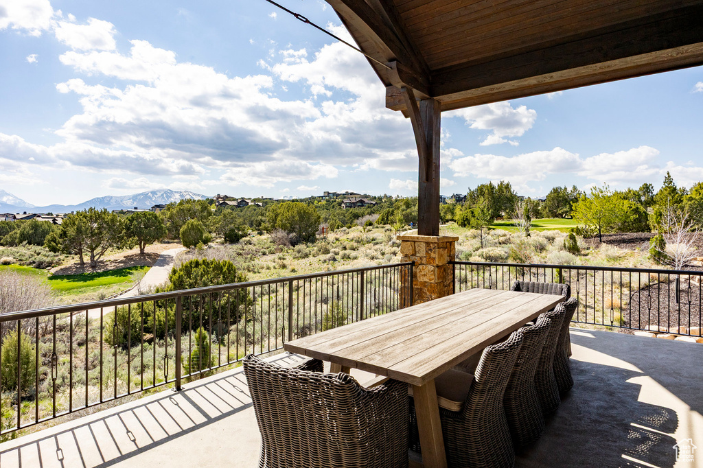 Balcony featuring a mountain view and outdoor dining space