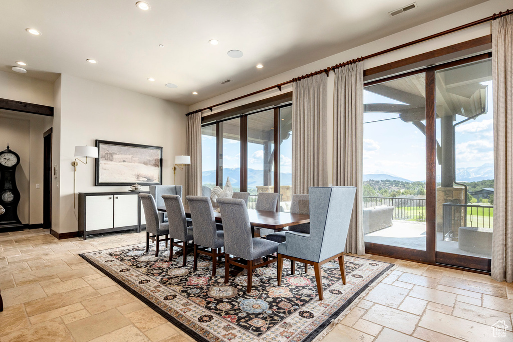 Dining area featuring recessed lighting, a mountain view, visible vents, and stone tile flooring