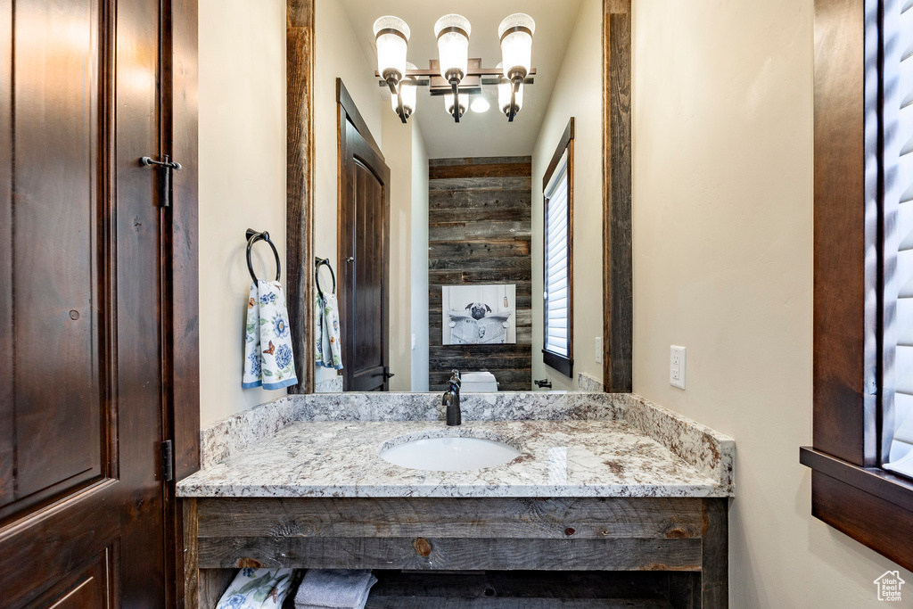 Bathroom featuring vanity and a chandelier