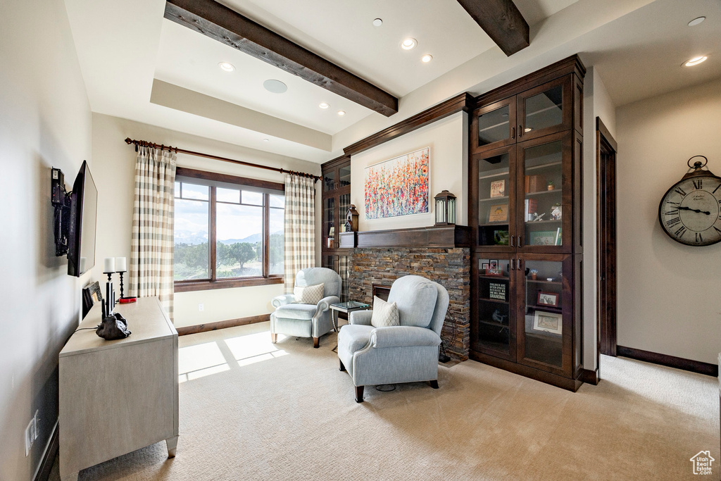 Sitting room with baseboards, beamed ceiling, recessed lighting, and light colored carpet