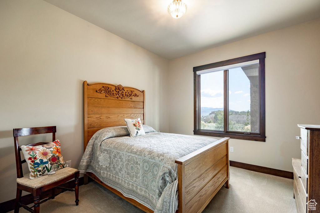 Bedroom featuring baseboards and light carpet