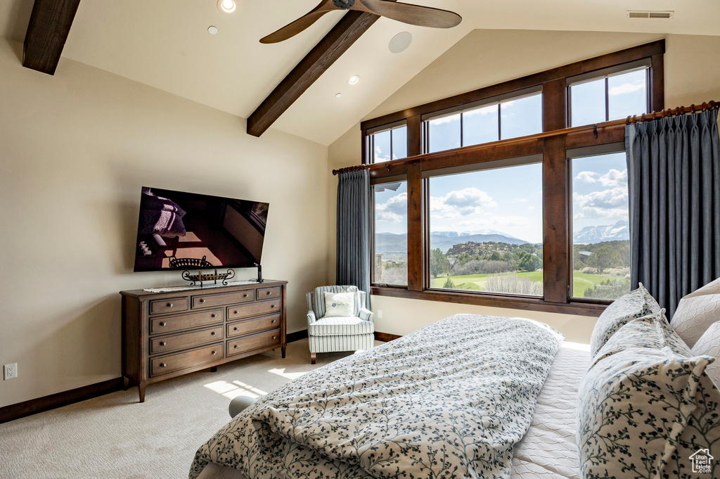 Bedroom featuring light colored carpet, multiple windows, beam ceiling, and visible vents